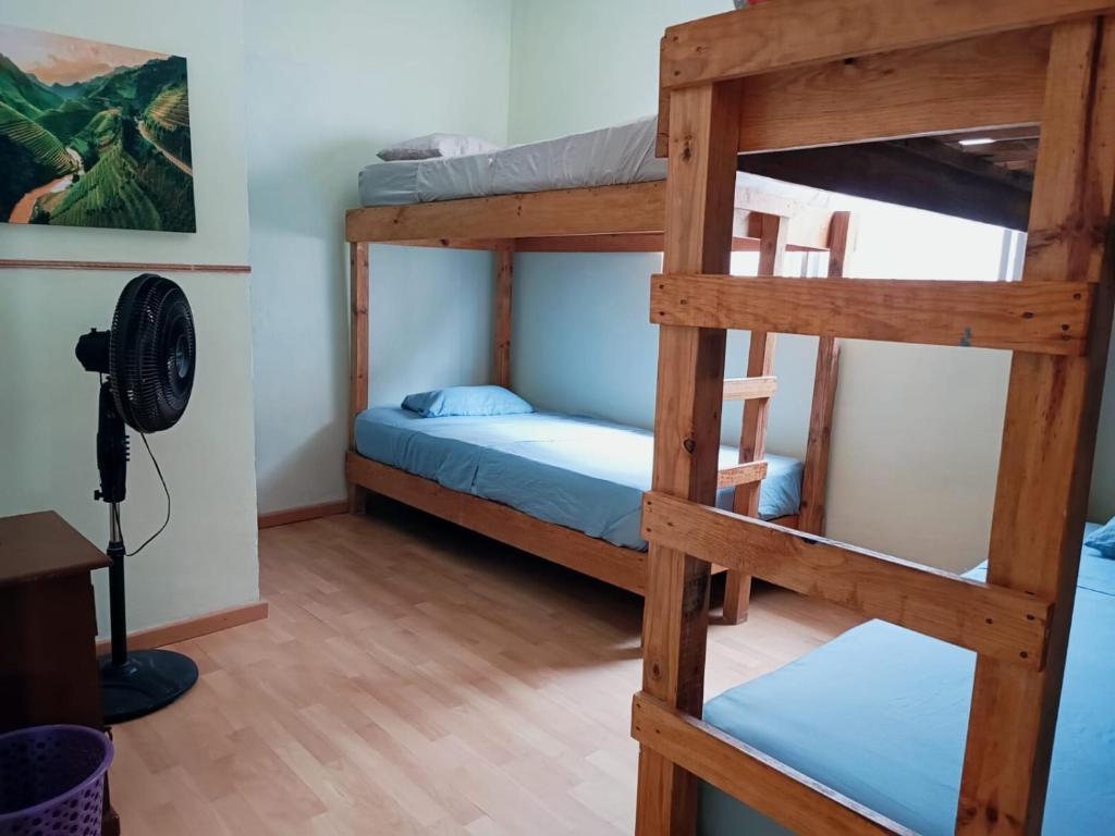 a room with two bunk beds and a fan at El Costeñito Hostal in Veracruz