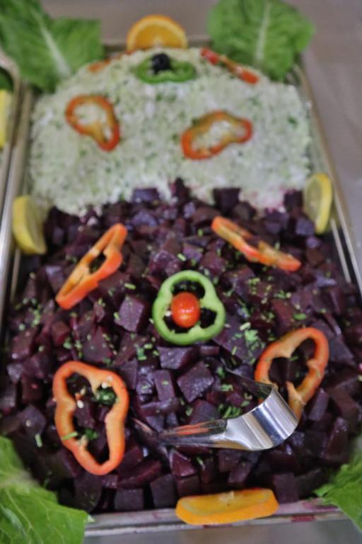 a tray of food with a plate of food with vegetables at Residence Touristique Merzouga in Merzouga