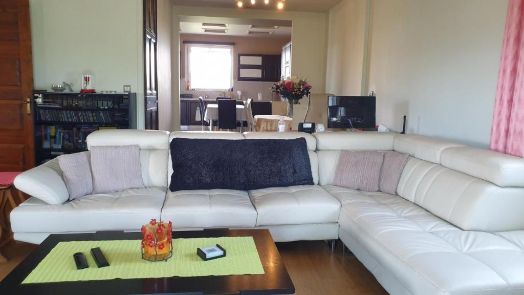 a living room with a white couch and a table at Wonderful Spot to Recharge in Kalamata