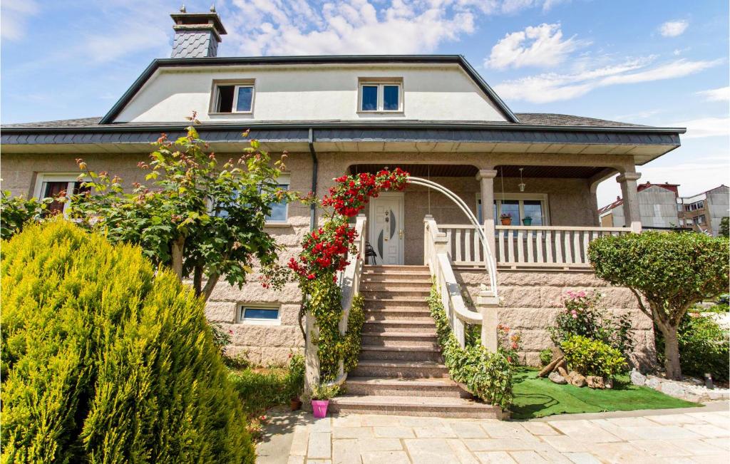 a house with flowers on the front porch at Amazing Home In Chantada With Wifi in Chantada