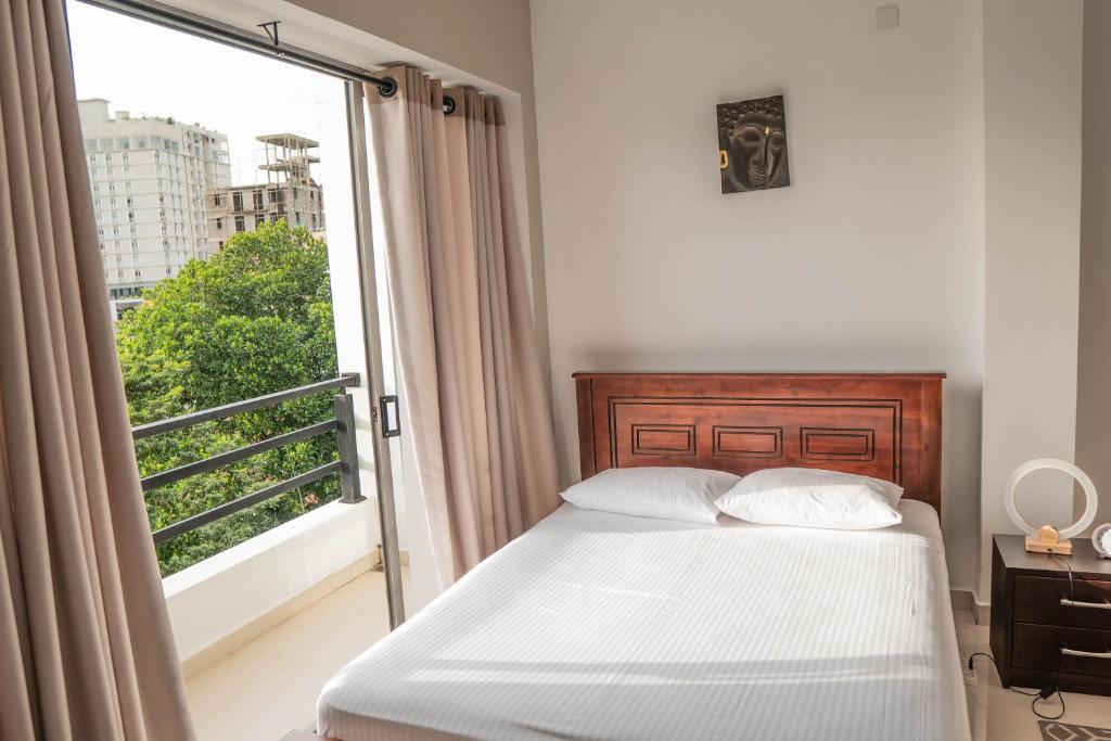 Tempat tidur dalam kamar di Bliss Apartments Colombo