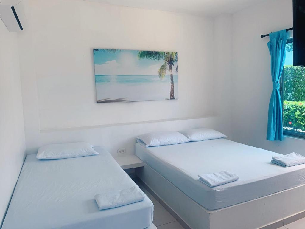 Postel nebo postele na pokoji v ubytování Blue Apartahotel
