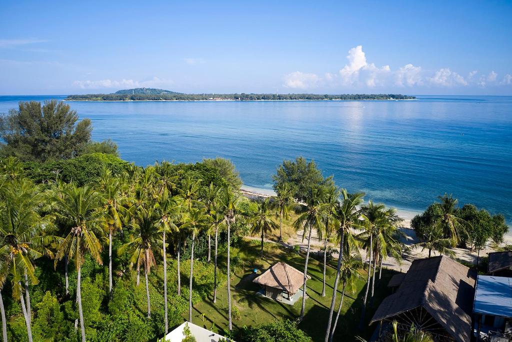 an aerial view of a beach with palm trees and the ocean at Ama-Lurra Resort in Gili Islands