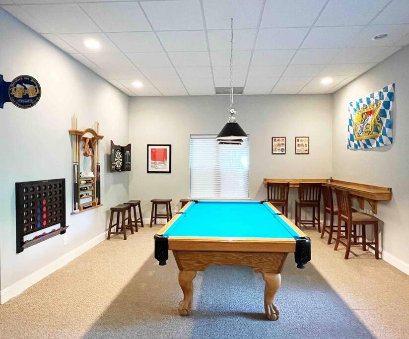 a pool table in the middle of a room at Peaceful treetop escape! Pool table, grill, games, sleeps 10! in Helen