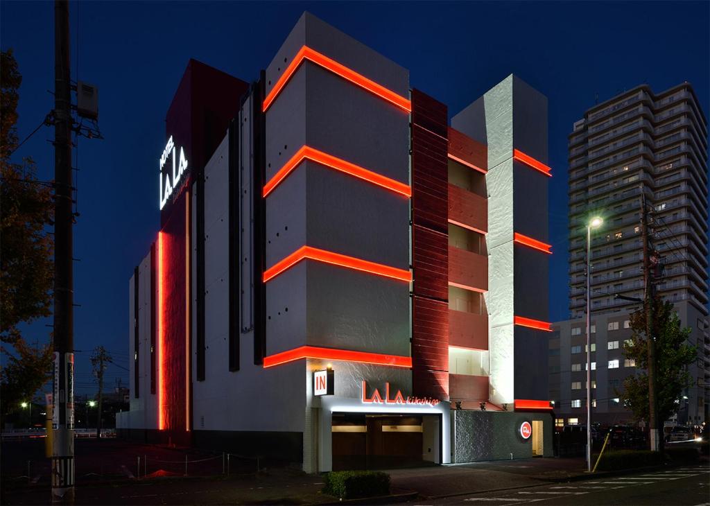 a building with red lights on the side of it at Hotel LALA - Kitashiga - (Adult Only) in Nagoya