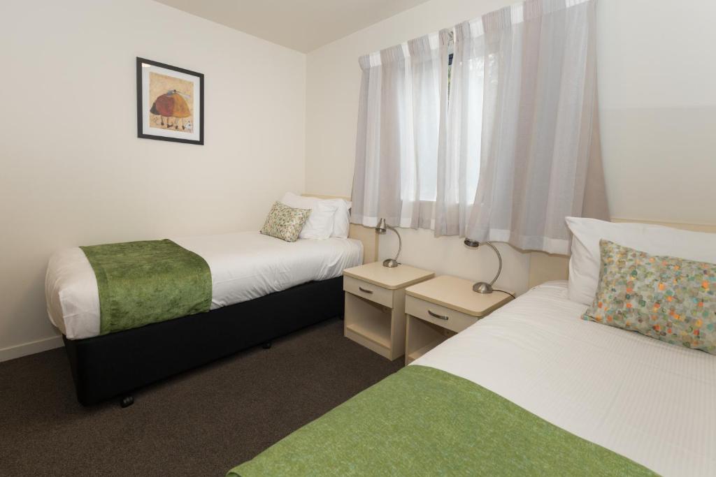 Postel nebo postele na pokoji v ubytování Bella Vista Motel Dunedin