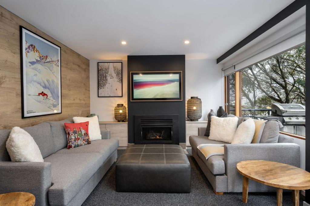 a living room with a couch and a fireplace at Golden Eagle 2 in Thredbo