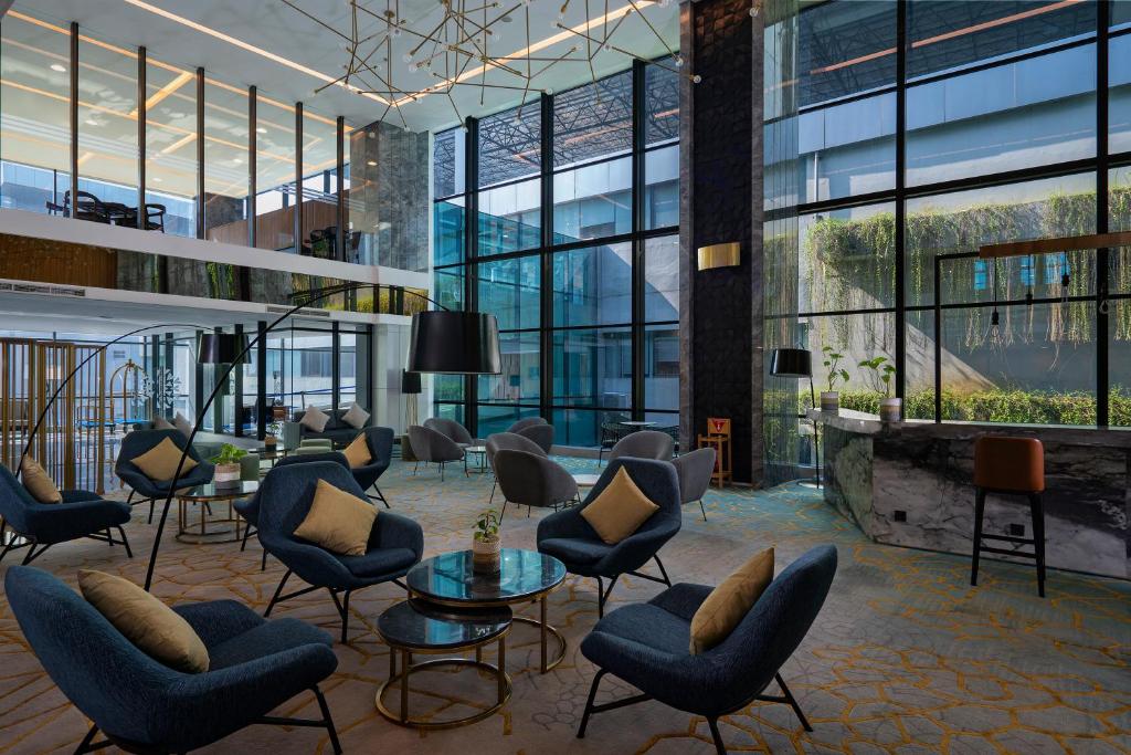 a rendering of a lobby with chairs and tables at Anara Airport Hotel in Tangerang