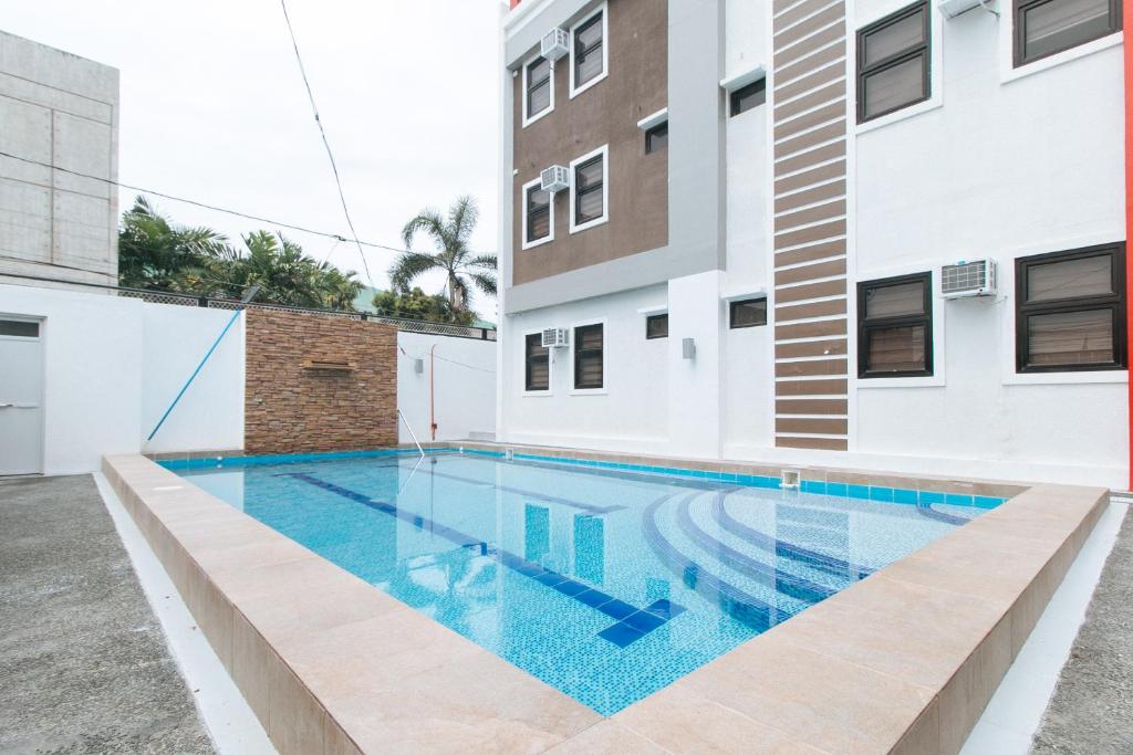 a swimming pool in the middle of a building at RedDoorz Plus @ d'Builders Poblacion - BGC in Manila