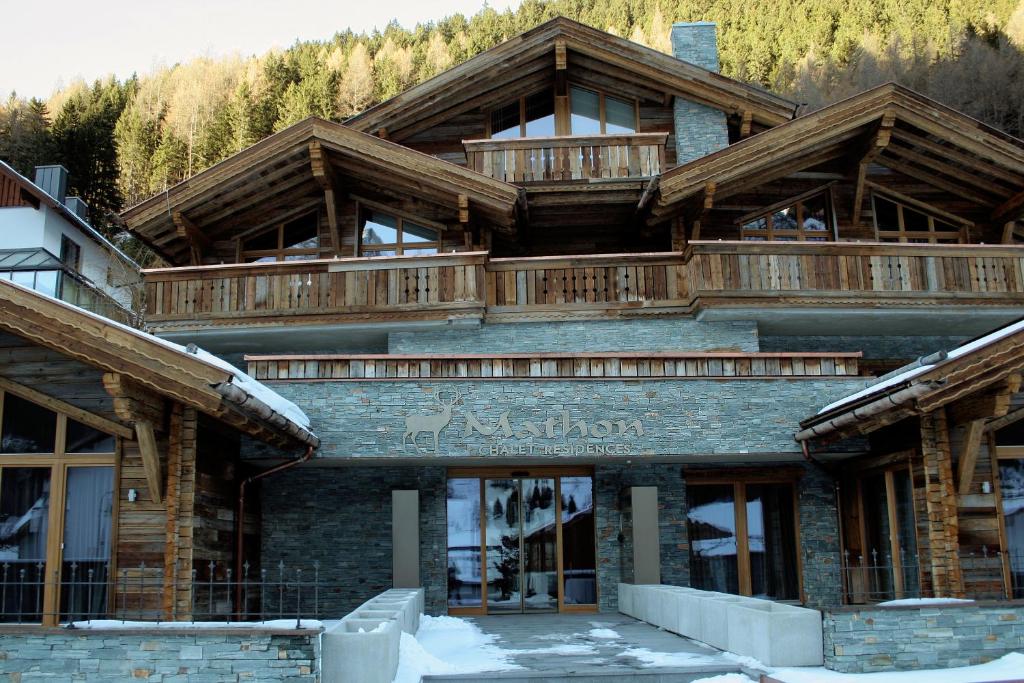 a large building with decks on top of it at Chalet Mathon in Ischgl