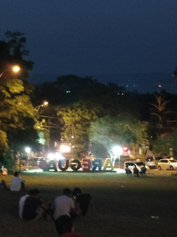 a group of people standing in a park at night at Hotel La Aparesida in Areguá