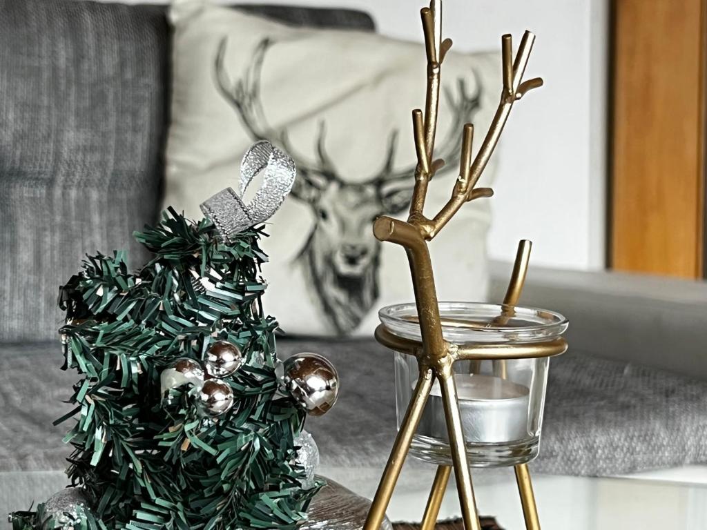 a table topped with a christmas tree and a trophy at Yeti Lux - Panoramic Loft in Garmisch-Partenkirchen