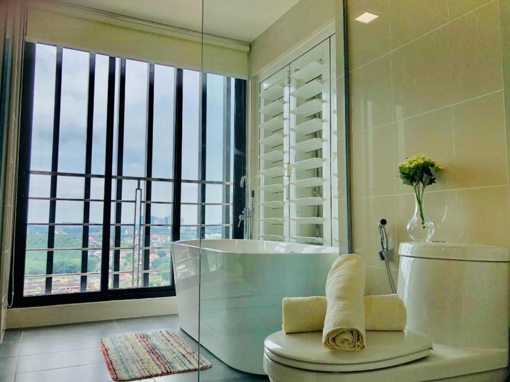 a bathroom with a tub and a large window at Southkey Mosaic by Antlerzone in Johor Bahru