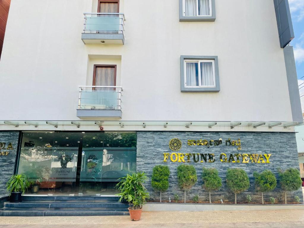 a white building with a sign for a future bakery at Treebo Trend Fortune Gateway in Yelahanka