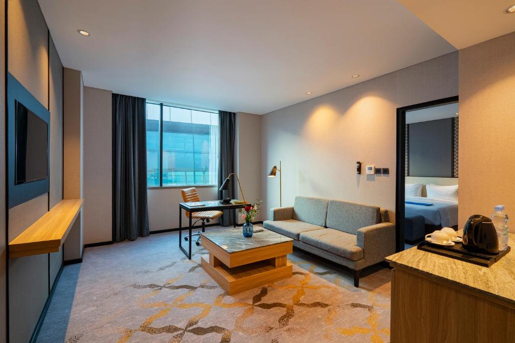 a living room with a couch and a table at Anara Airport Hotel in Tangerang