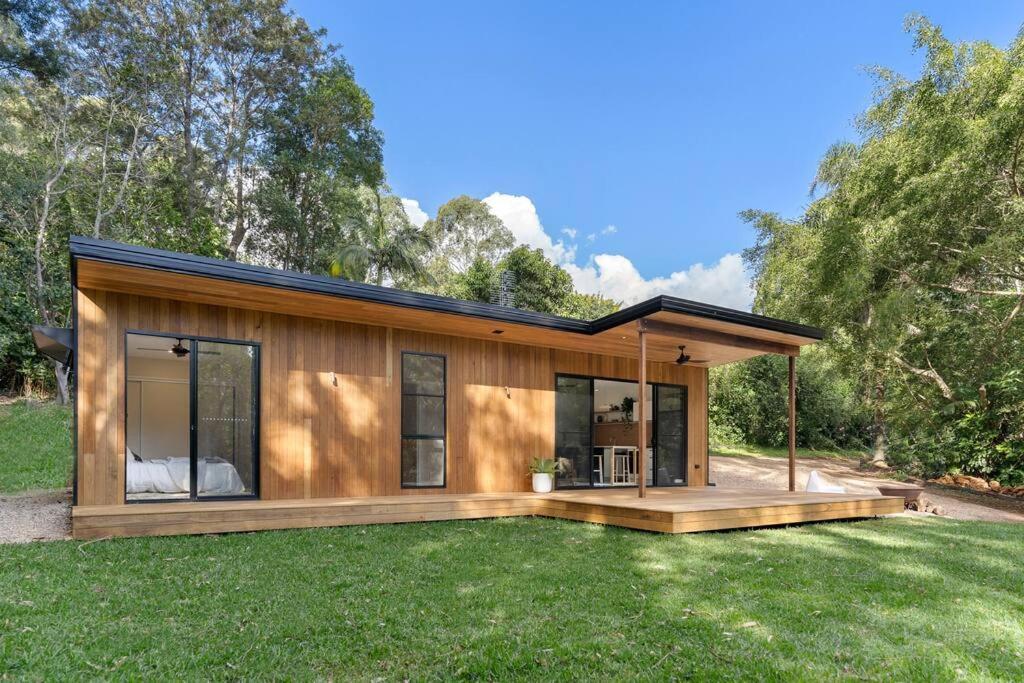 a modular home with a deck and grass at The Brook View Byron Bay in Ewingsdale