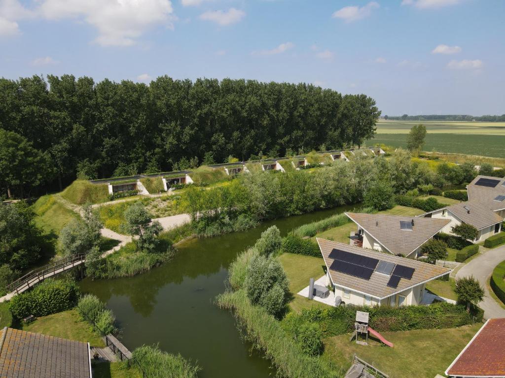 an aerial view of a river with houses and a house at Zeeuwse Dijksuite in Kortgene