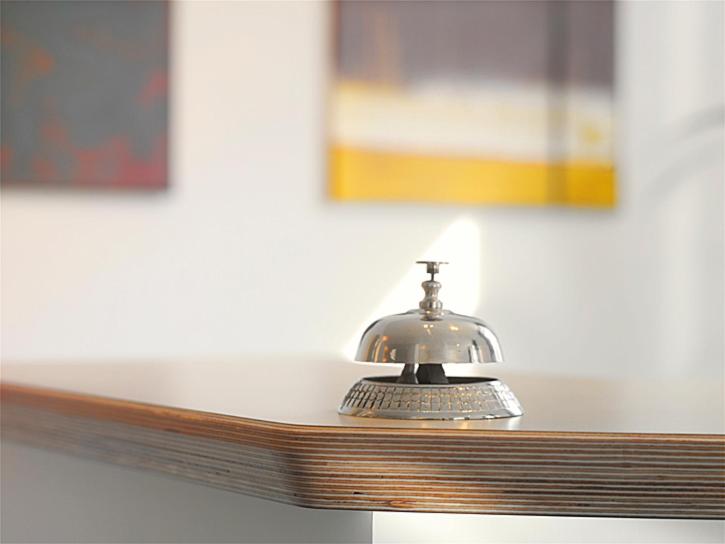 a silver bell sitting on top of a table at Hotel Domicil Lebensart in Neuenhaus