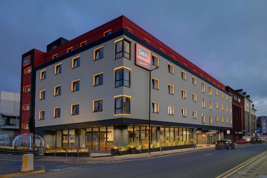 a large building on the corner of a street at Sadie Best Western Hotel at Luton in Luton