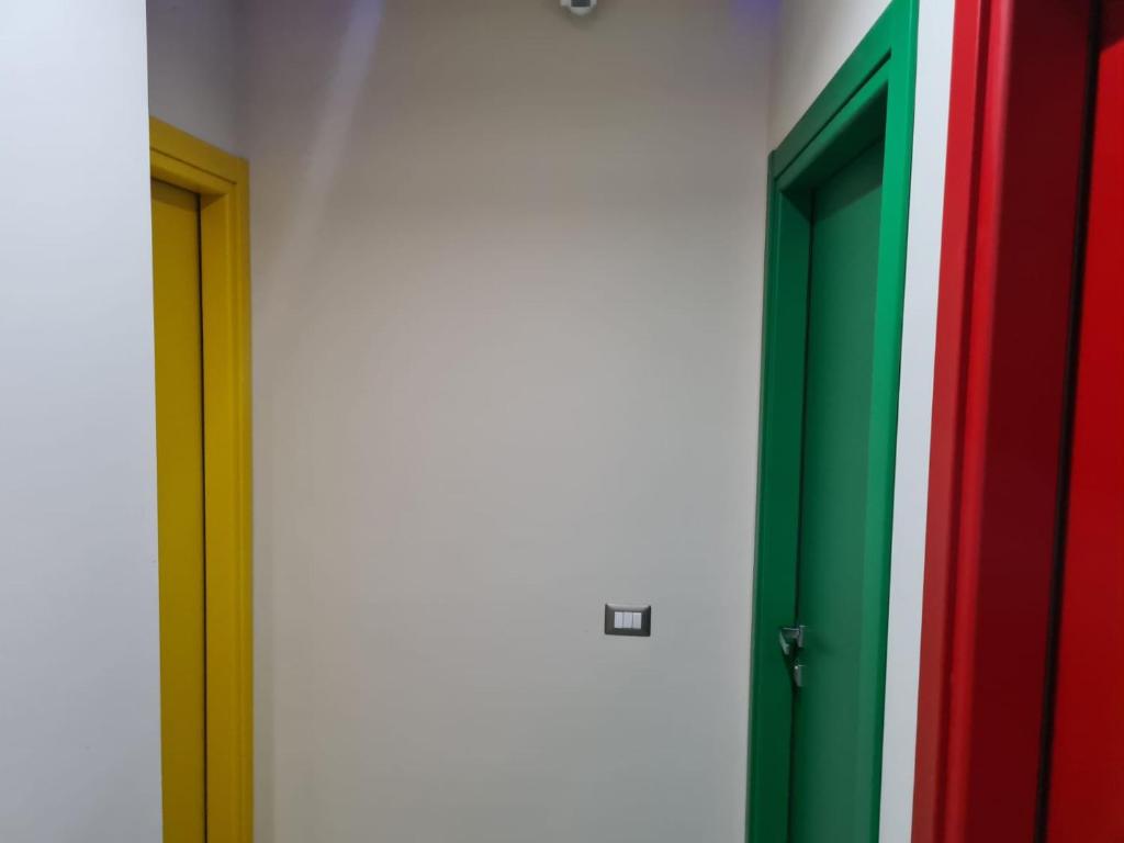 a row of doors with different colored doors at ARCOBALENO by DIMORA CHIC in Novara