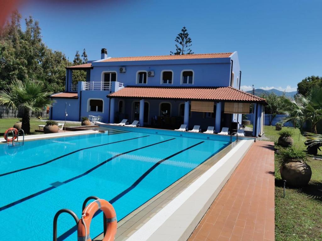 une villa avec une piscine en face d'une maison dans l'établissement Villa Maria Marchesana, à Pezzi di Gala