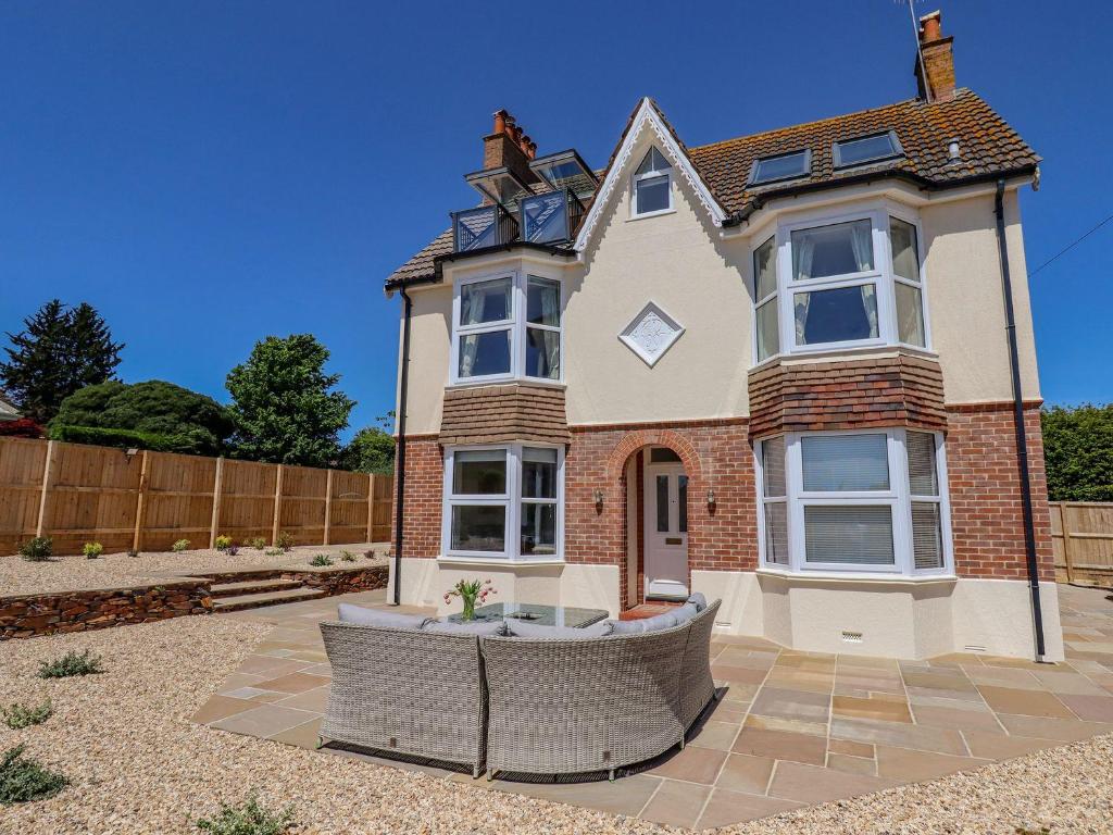 a large house with a fence in front of it at Temple House in Sidmouth