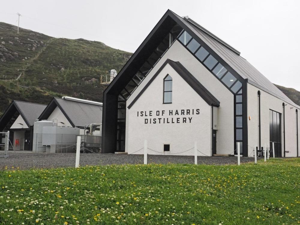 a black and white building with a sign on it at Old Post Office in Tarbert