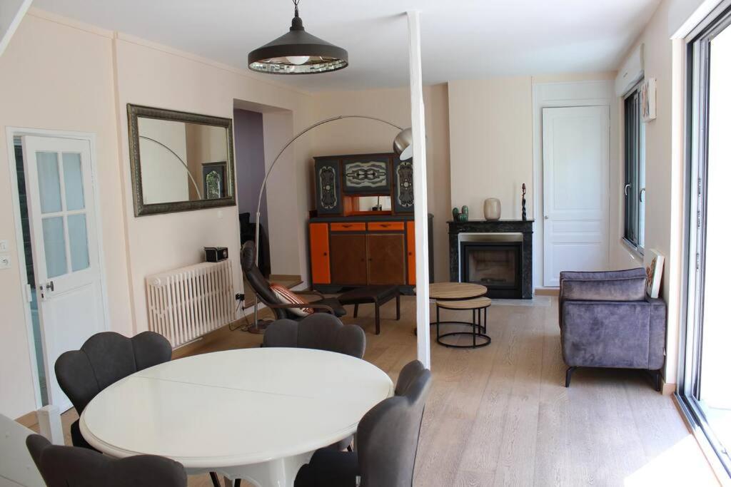 a living room with a white table and a couch at Charmante Maison de Ville avec Jardin quartier Prébendes in Tours