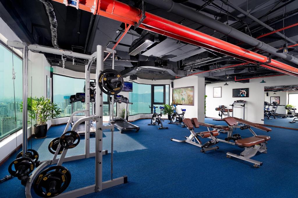 A sea-facing fitness room with free weights, benches and cardio equipment.