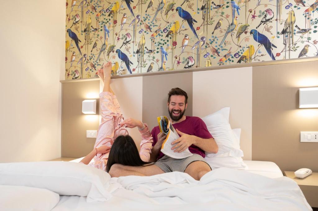 Łóżko lub łóżka w pokoju w obiekcie L'Hotel