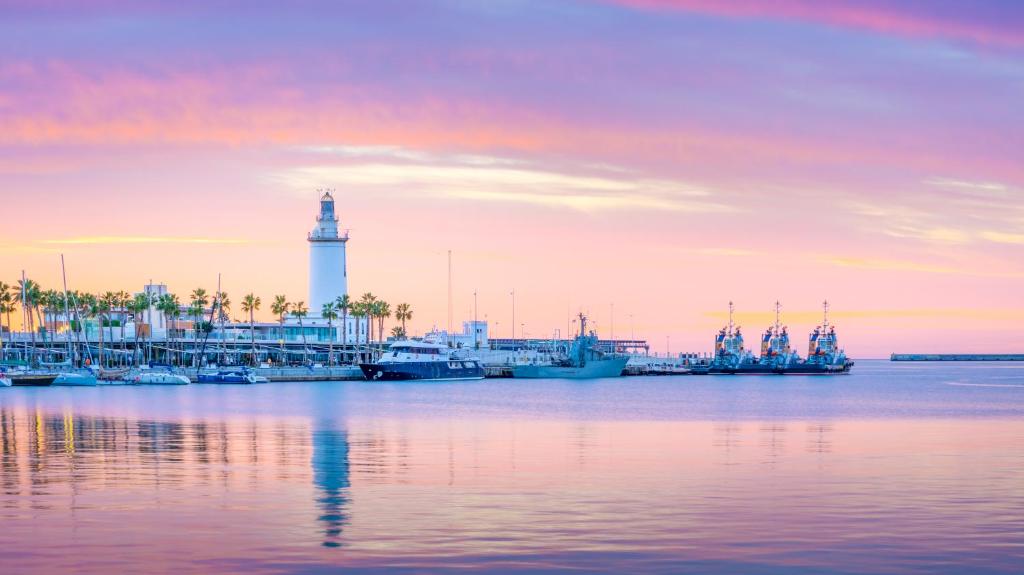 a lighthouse in the middle of a body of water at Ibis Malaga Centro Ciudad in Málaga