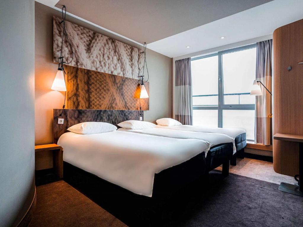 Postel nebo postele na pokoji v ubytování Ibis Den Haag City Centre