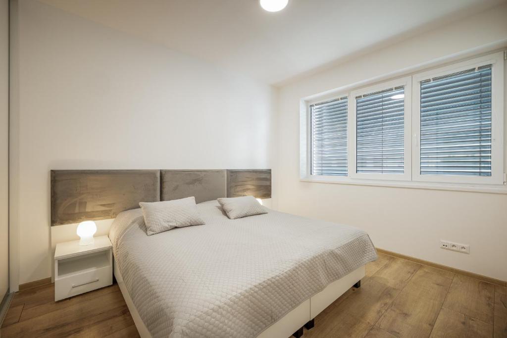 A bed or beds in a room at Apartmán LUXURY