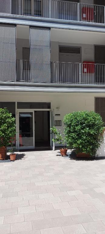 a building with two trees in front of it at Feel Like Home In Milan in Milan