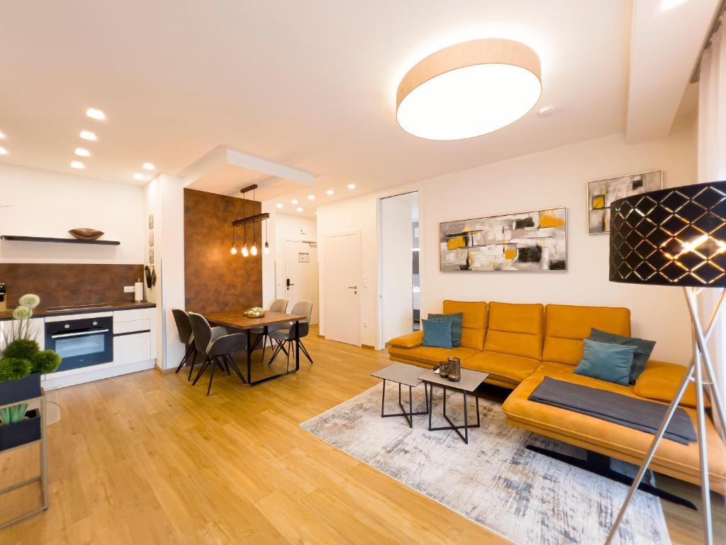 a living room with a yellow couch and a table at VIVA Apartments in Graz