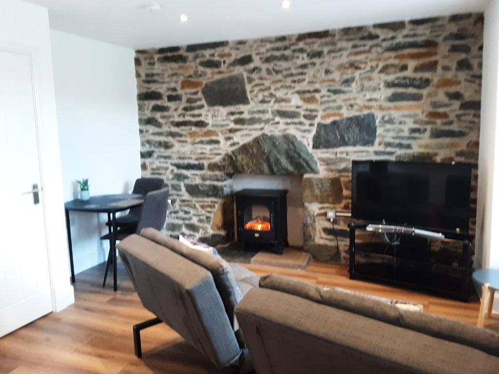 a living room with a couch and a fireplace at CRAIGLEA HEATHER in Killin