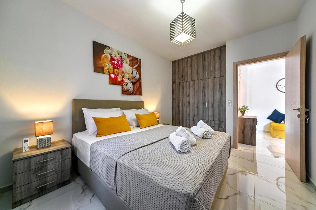 a bedroom with a bed with two pillows on it at Seaside Apartment 1 in Hersonissos