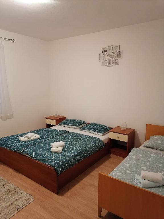 Postel nebo postele na pokoji v ubytování Apartments Zdenka