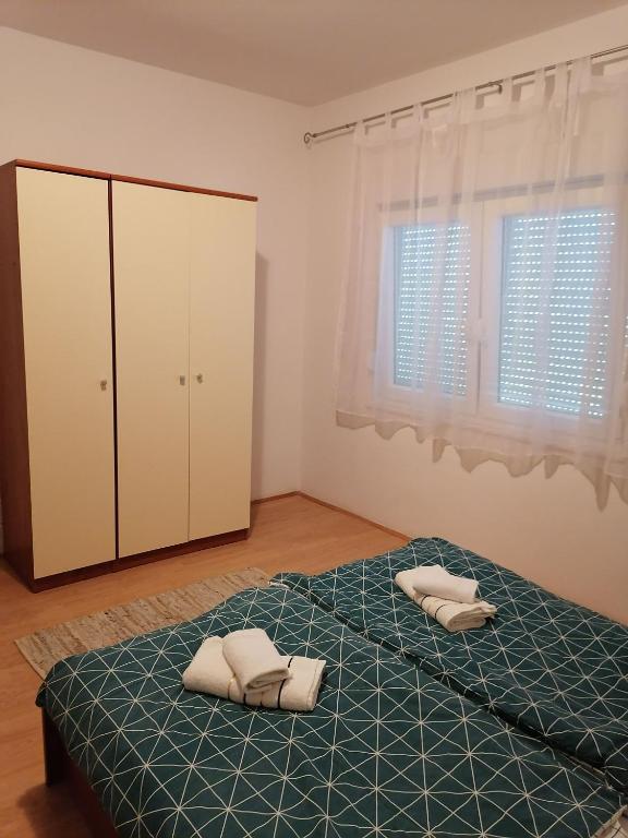 Postel nebo postele na pokoji v ubytování Apartments Zdenka