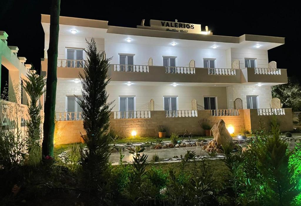 a large white building at night with lights on at Hotel Valerios in Kriopigi