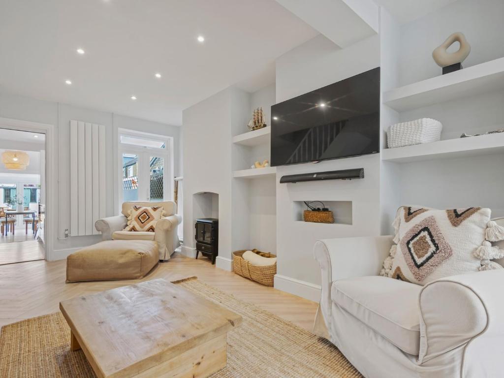 a living room with white furniture and a table at Pass the Keys 3 bed Scandi Heaven minutes from the beach in Whitstable