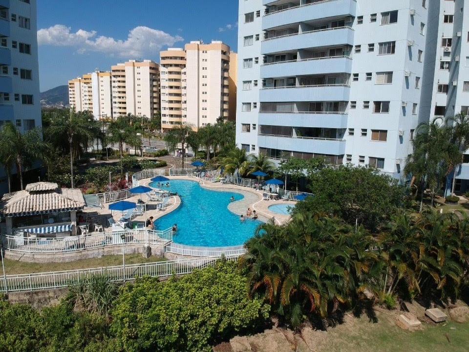 a view of a swimming pool in a resort at Apartamento Vila DR - Barra da Tijuca,prox Jeunesse,Arenas,Rio Centro,praias, Shopping in Rio de Janeiro