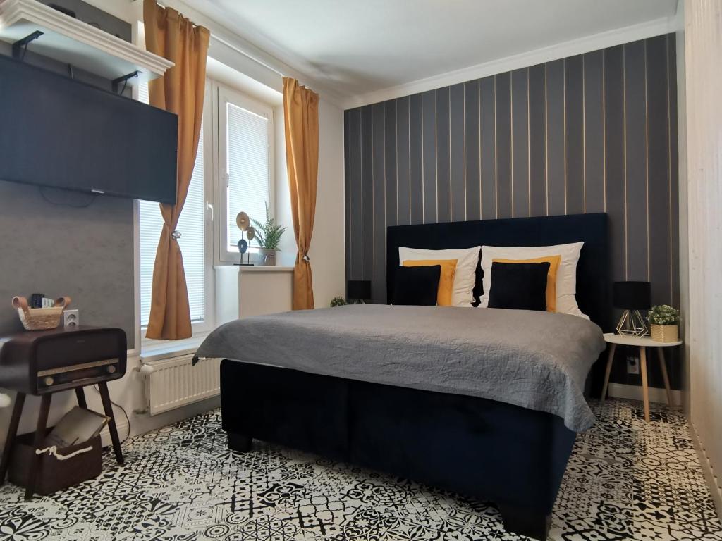 a bedroom with a large bed and a window at PÁLFFY in Bratislava