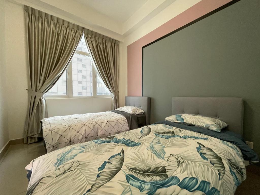 a bedroom with two beds and a window at Delight Homestay Twin Galaxy Studio Room in Johor Bahru