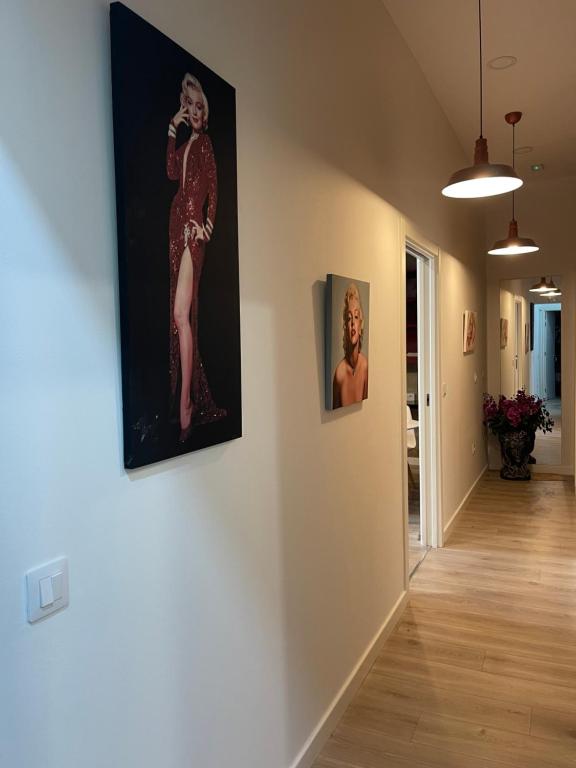 a hallway with two paintings of a woman on the wall at Espacio Room Fuerteventura in Puerto del Rosario