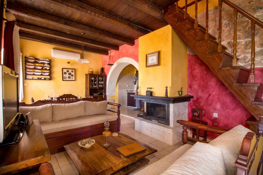 a living room with a couch and a fireplace at Samonas - Red villa Fliskouni in Chania