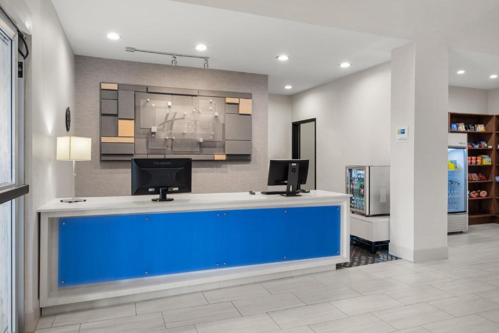 a salon with a large blue pool in a room at Holiday Inn Express & Suites Graham, an IHG Hotel in Graham