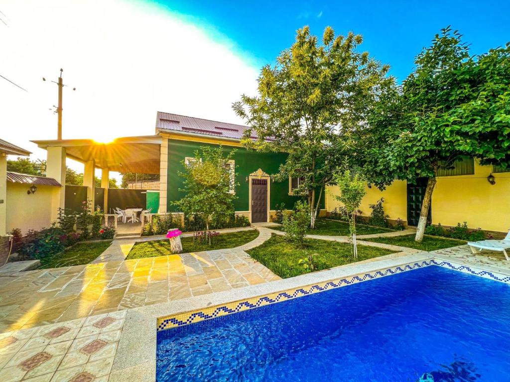 a house with a swimming pool in the yard at Qafqaz Mini Villa in Gabala