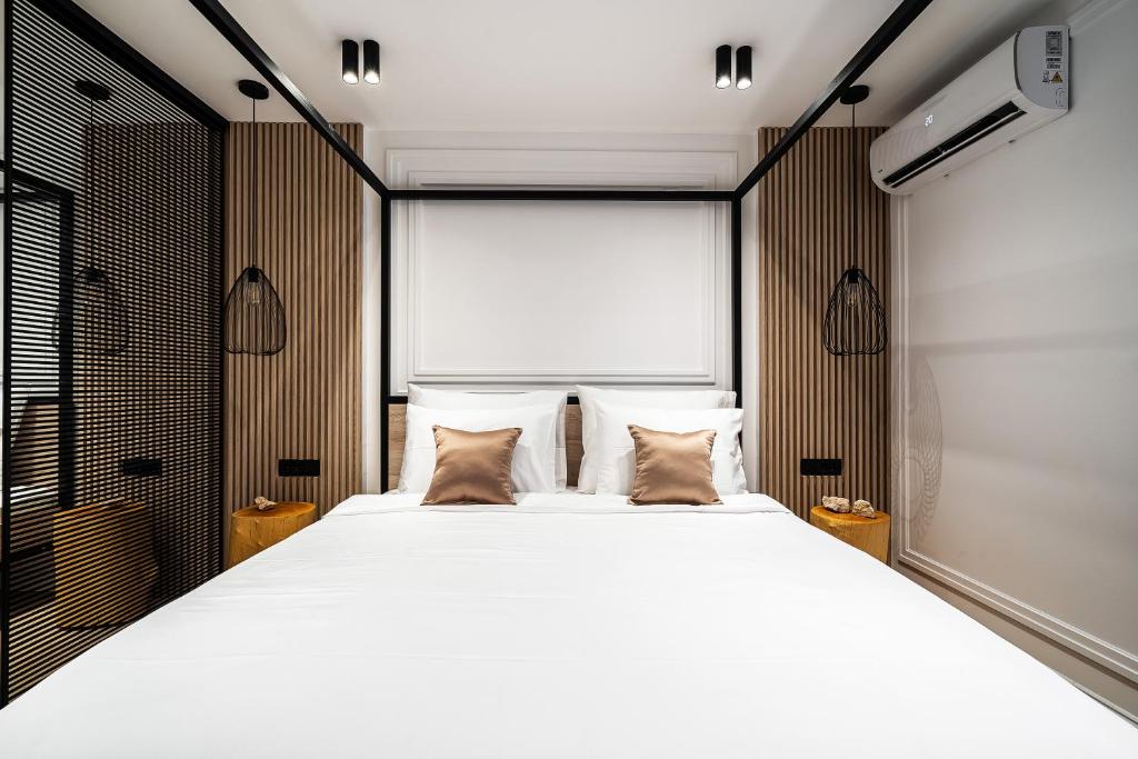 a bedroom with a large white bed with two pillows at Blanche Cliff Apartments in Sveti Stefan