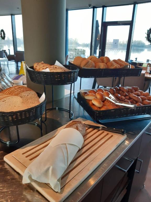 a bakery with bread and pastries on a counter at Domein Polderwind in Zuienkerke